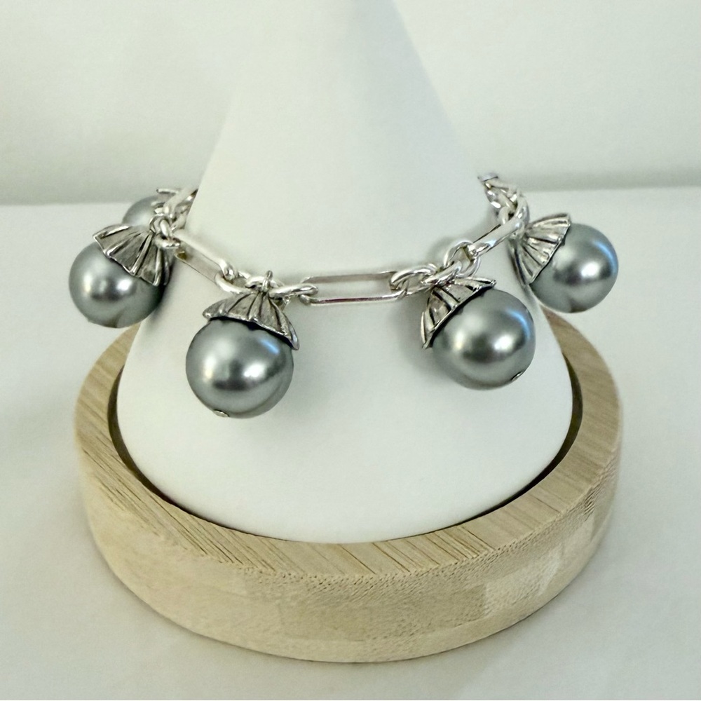 Unique Silver Charm Bracelet With Silver Pearls And Decorative Cone Caps